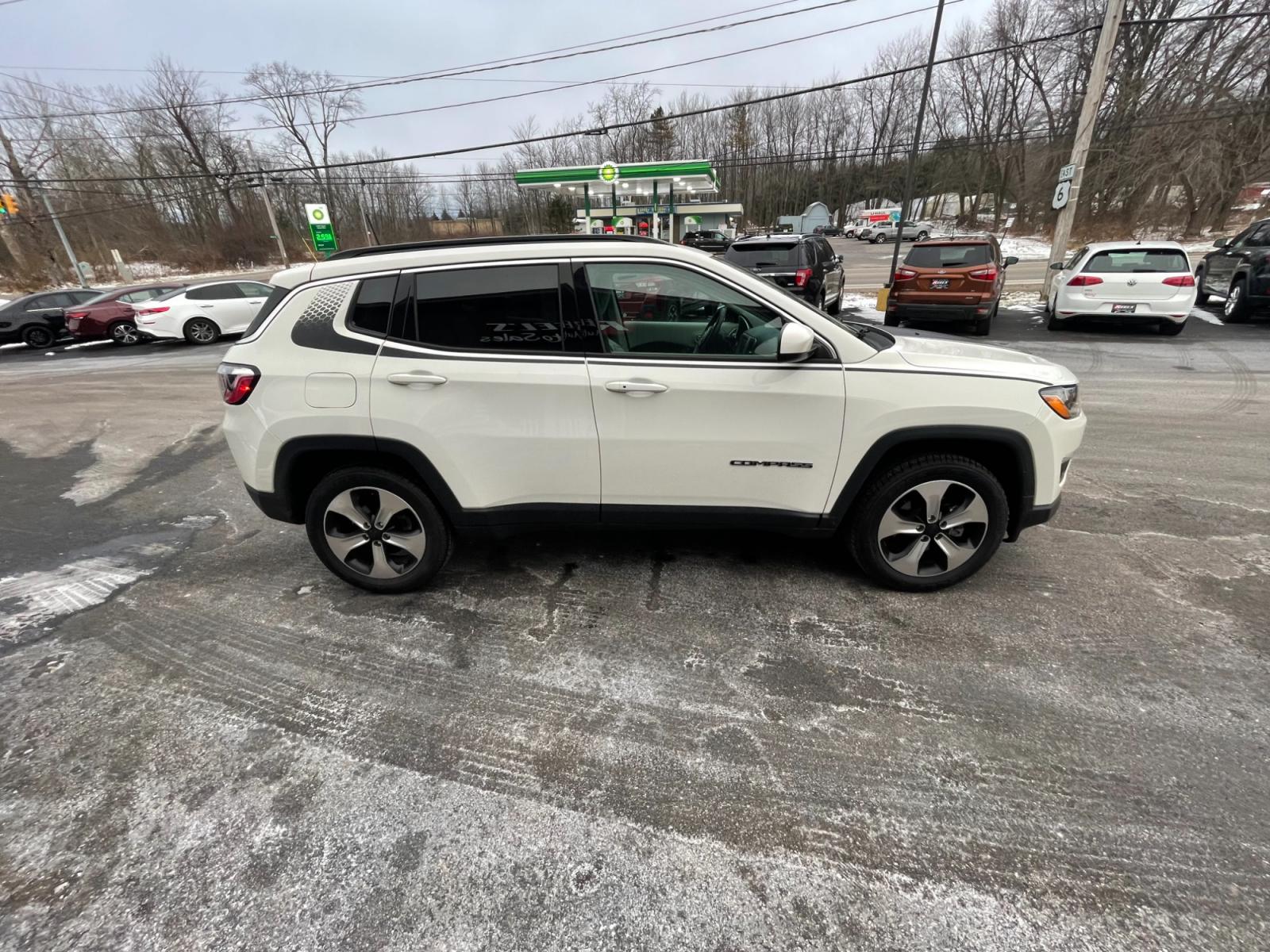 2018 White /White Jeep Compass Latitude 4WD (3C4NJDBB3JT) with an 2.4L I4 DOHC 16V engine, 9 Speed Automatic transmission, located at 11115 Chardon Rd. , Chardon, OH, 44024, (440) 214-9705, 41.580246, -81.241943 - This 2018 Jeep Compass Latitude 4WD with a 2.4-liter engine and 9-speed automatic transmission offers a blend of utility and comfort with its heated leather seats and dual-zone automatic climate control. The 8.4-inch touchscreen provides user-friendly access to navigation, Apple CarPlay, and Android - Photo #6
